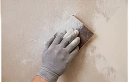 Sanding and patching an interior wall before painting